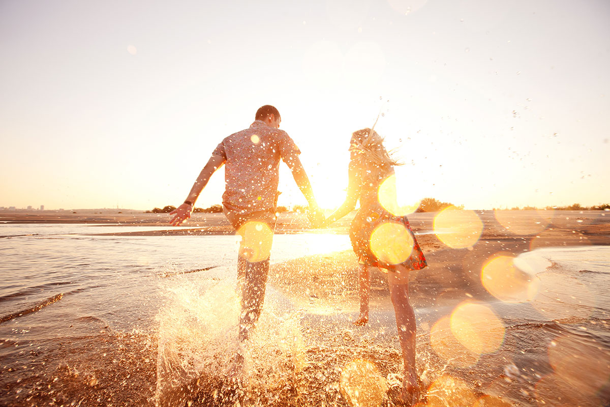 Plan Your Perfect Day and We’ll Tell You the True Age of Your Soul Happy Couple On Beach