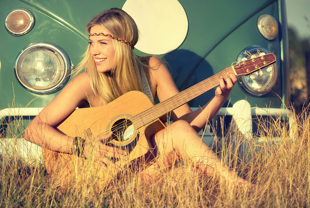 How Well Do You Know Hippie Slang? Hippie Woman Playing Guitar