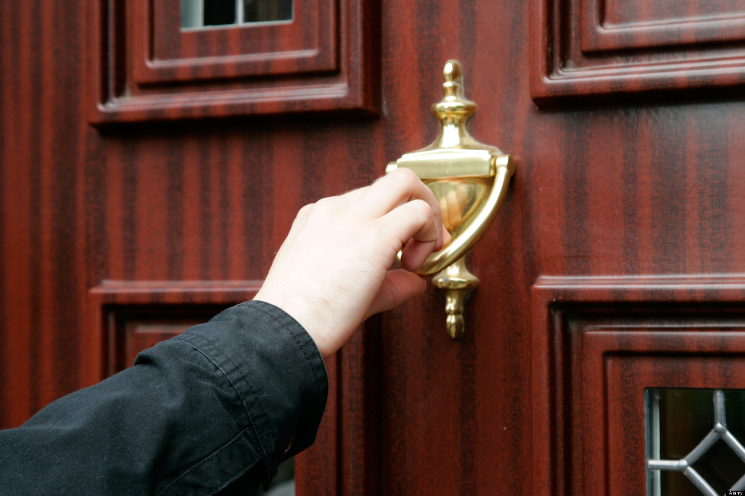 🚯 Can You Guess If These Weird Laws Are Real? mans hand using door knocker on wood effect upvc door cold calling household