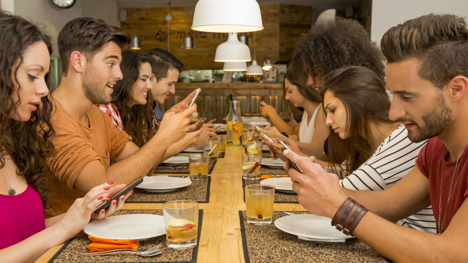 📱 We’ll Tell You How Addicted You Are to the Internet Based on How Often You Do These Things checking phone at dinner