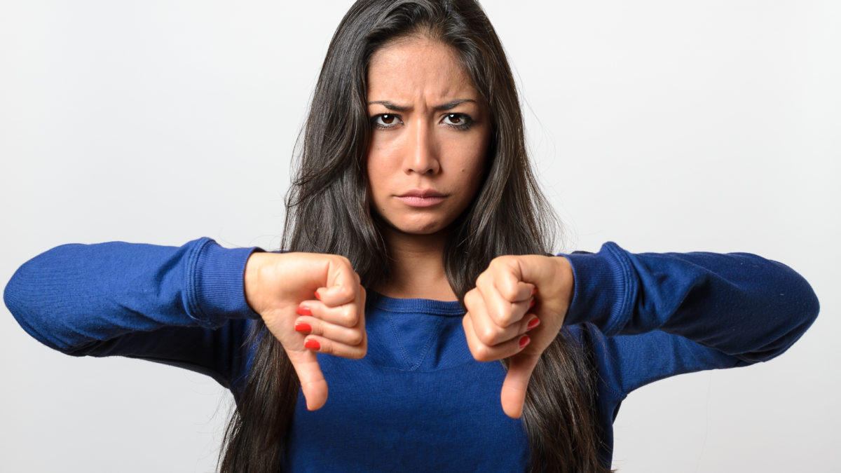 Can We Guess Your Age Based on This List of Tasks? Rebellious Negative Woman Giving A Thumbs Down
