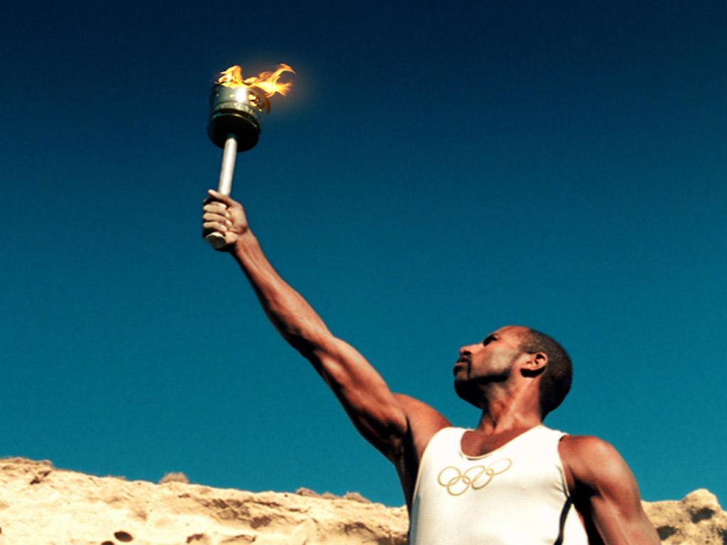 Only TV Fans Can Name These TV’s Most Historic Moments carrying olympic torch
