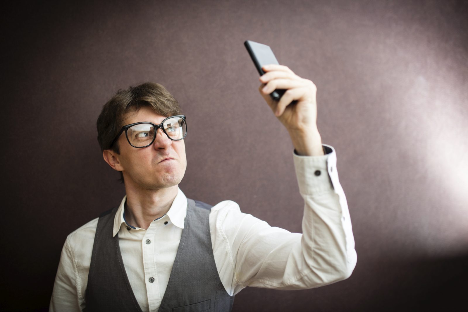 How Petty Are You? Quiz Angry man with mobile smartphone