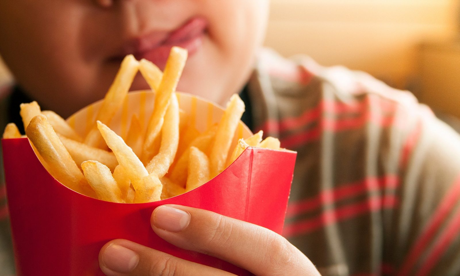 🍴 If You Eat 8/25 of These Foods With a Fork, You’re Forking Ridiculous Cropped Image Of Tempted Boy Holding French Fries Packet