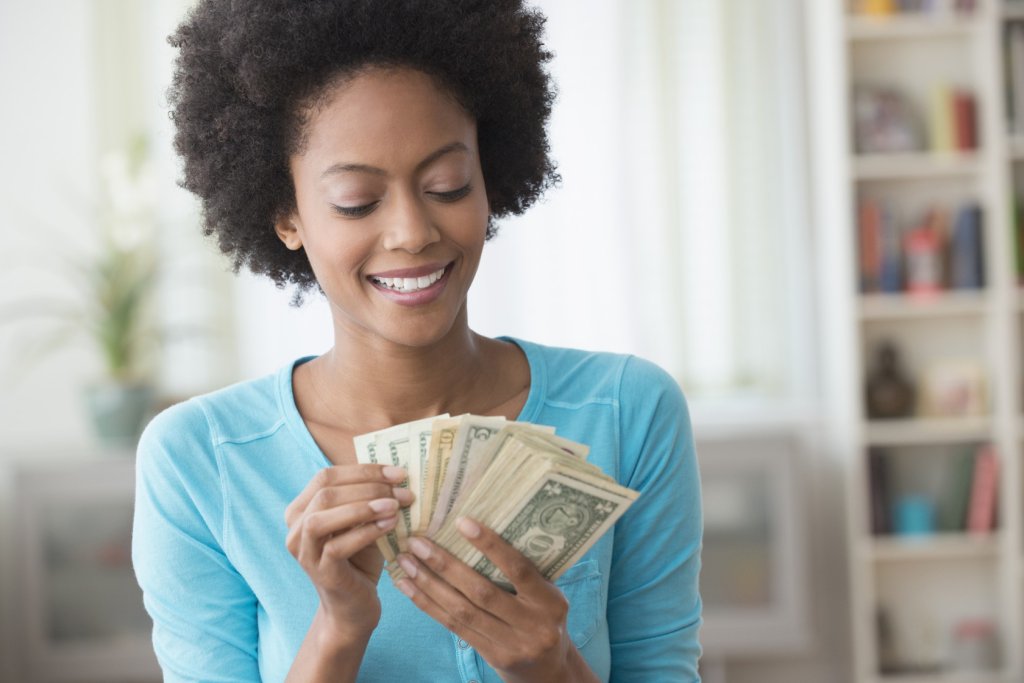This “Would You Rather” Quiz Will Determine Your True Age Woman counting money