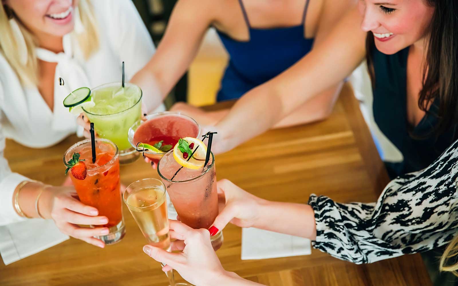 We Know Where You Live Based on the Meals You Order Caucasian women toasting at bar with cocktails