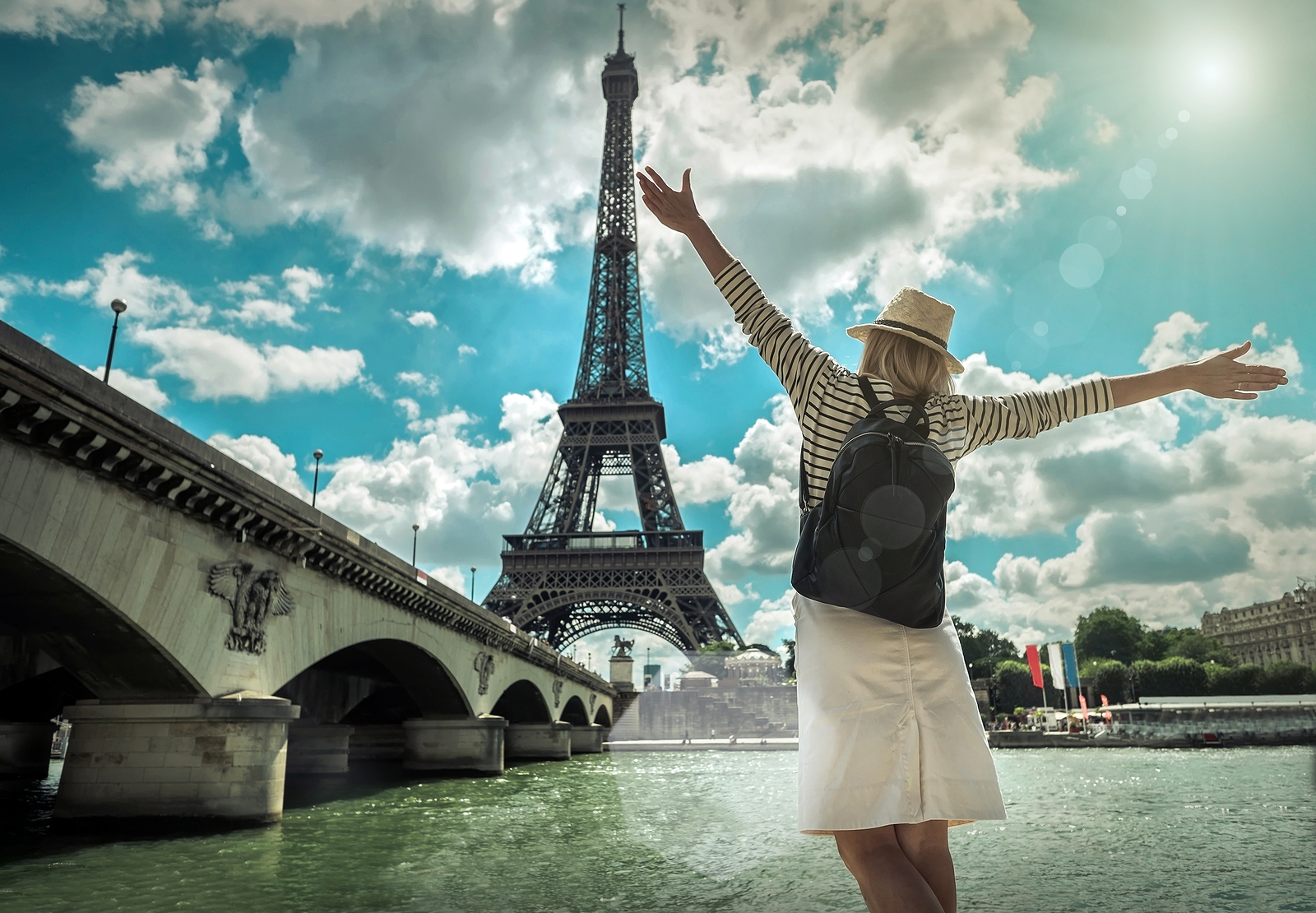 This Science “True or False” Quiz Will Reveal If You Aced or Flunked Out of School Woman tourist selfie near the Eiffel tower in Paris under sunlight