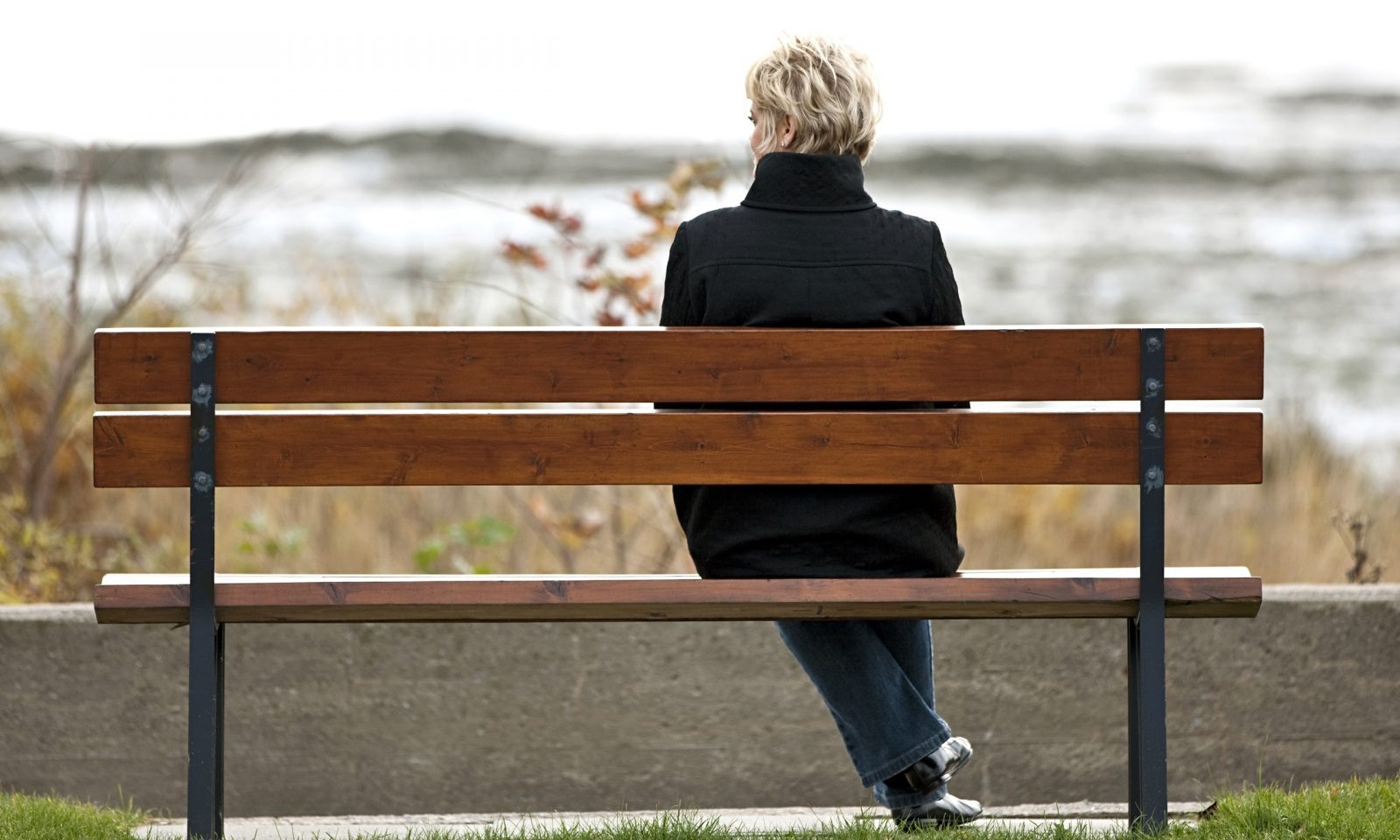 Woman sitting alone on park bench