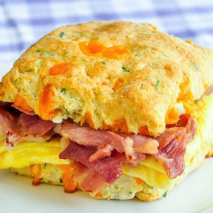 Pretend to Order an Expensive Brunch and We’ll Reveal Whether You’re More Millionaire or Billionaire Material Ham and cheddar scallion biscuit sandwich