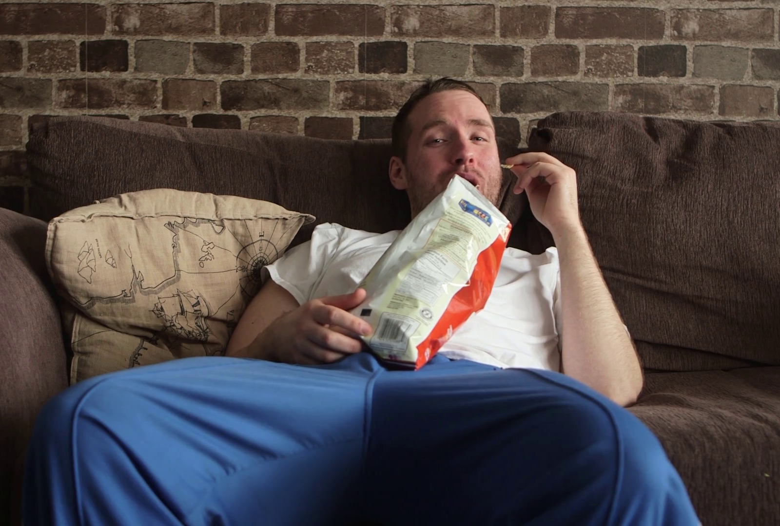 What Potato Chip Flavor Are You? a lazy man sitting on his couch eating potato chips watching tv and and laughing_remmt5r2_thumbnail full01