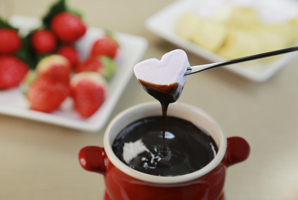 🍫 Can We Guess If You’re Single from Your Taste in Chocolate? dipping marshmallows in chocolate fondue