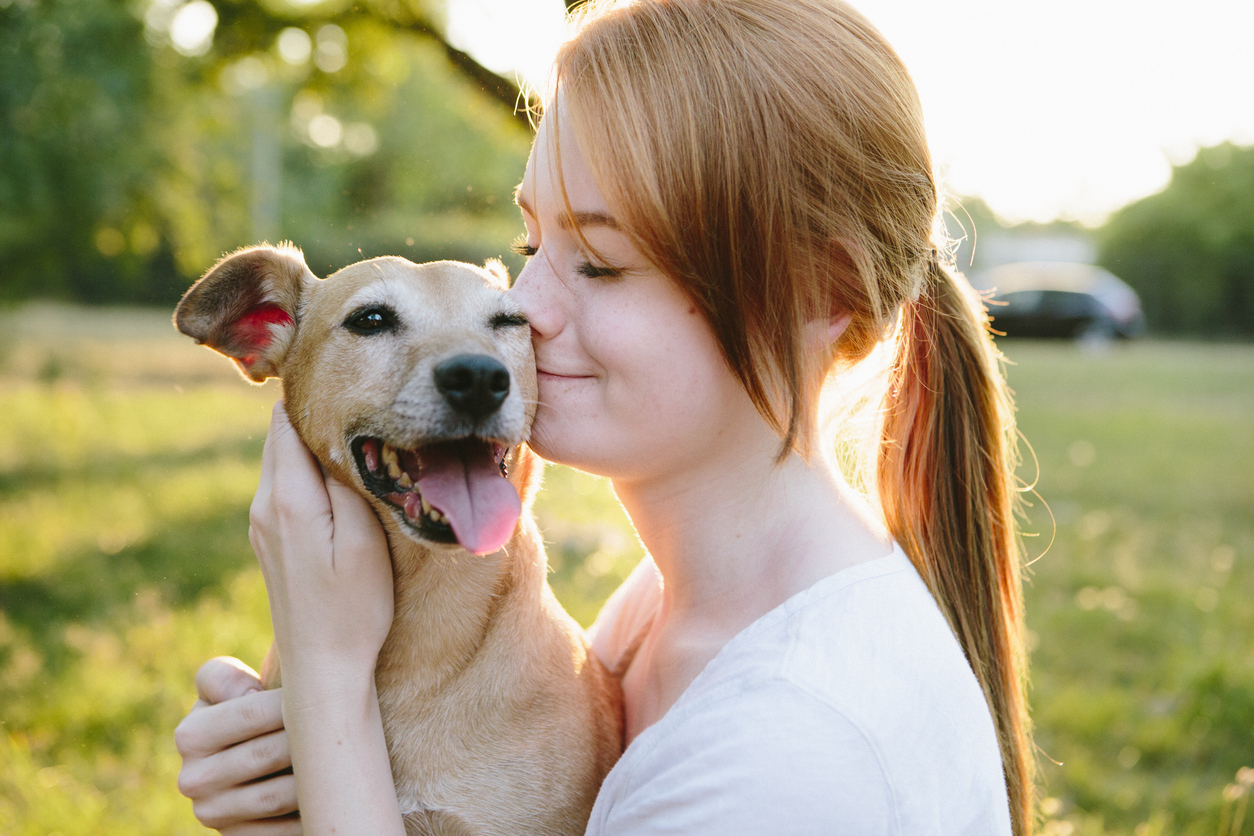 What Hot Chocolate Are You? young redhead woman hug her small Mixed breed dog