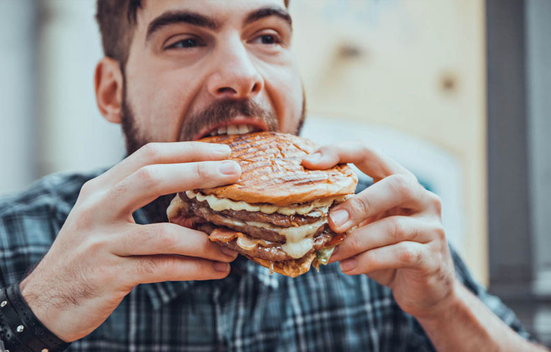 🍔 Only Calorie Experts Can Tell Which Fast Food Burgers Have More Calories Man Eating Burger