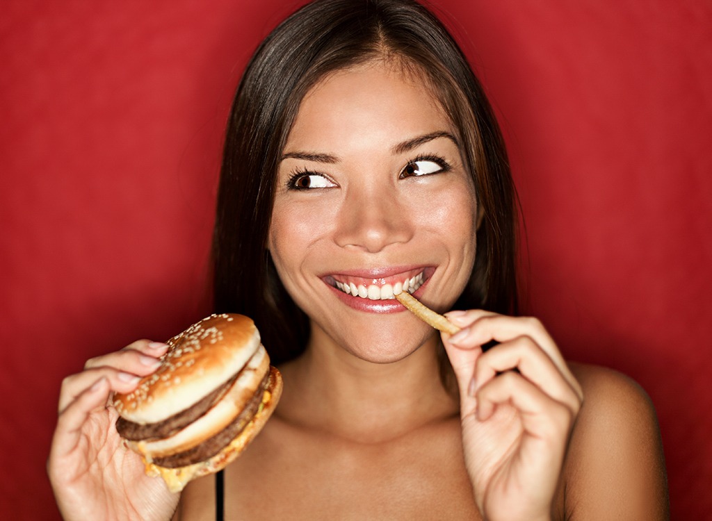 🍔 Only Calorie Experts Can Tell Which Fast Food Burgers Have More Calories Woman eating burger