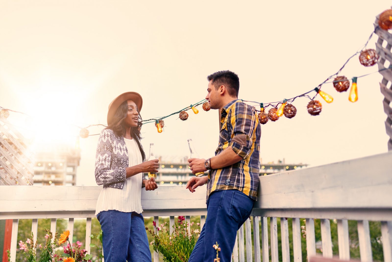 Are You Easily Annoyed? This Quiz Will Reveal How Much Patience You Have Multi ethnic millenial couple flirting while having a drink on rooftop terrasse at sunset