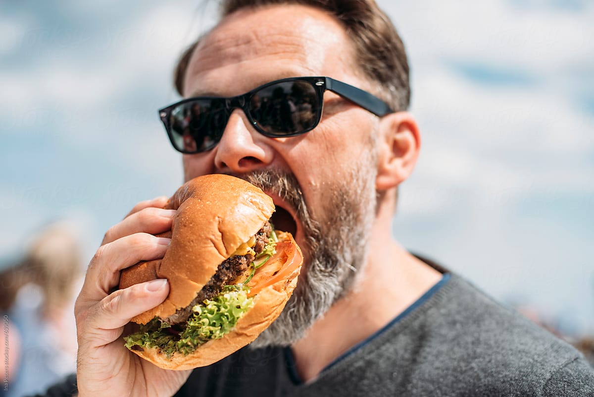 Man Eating A Beef Burger