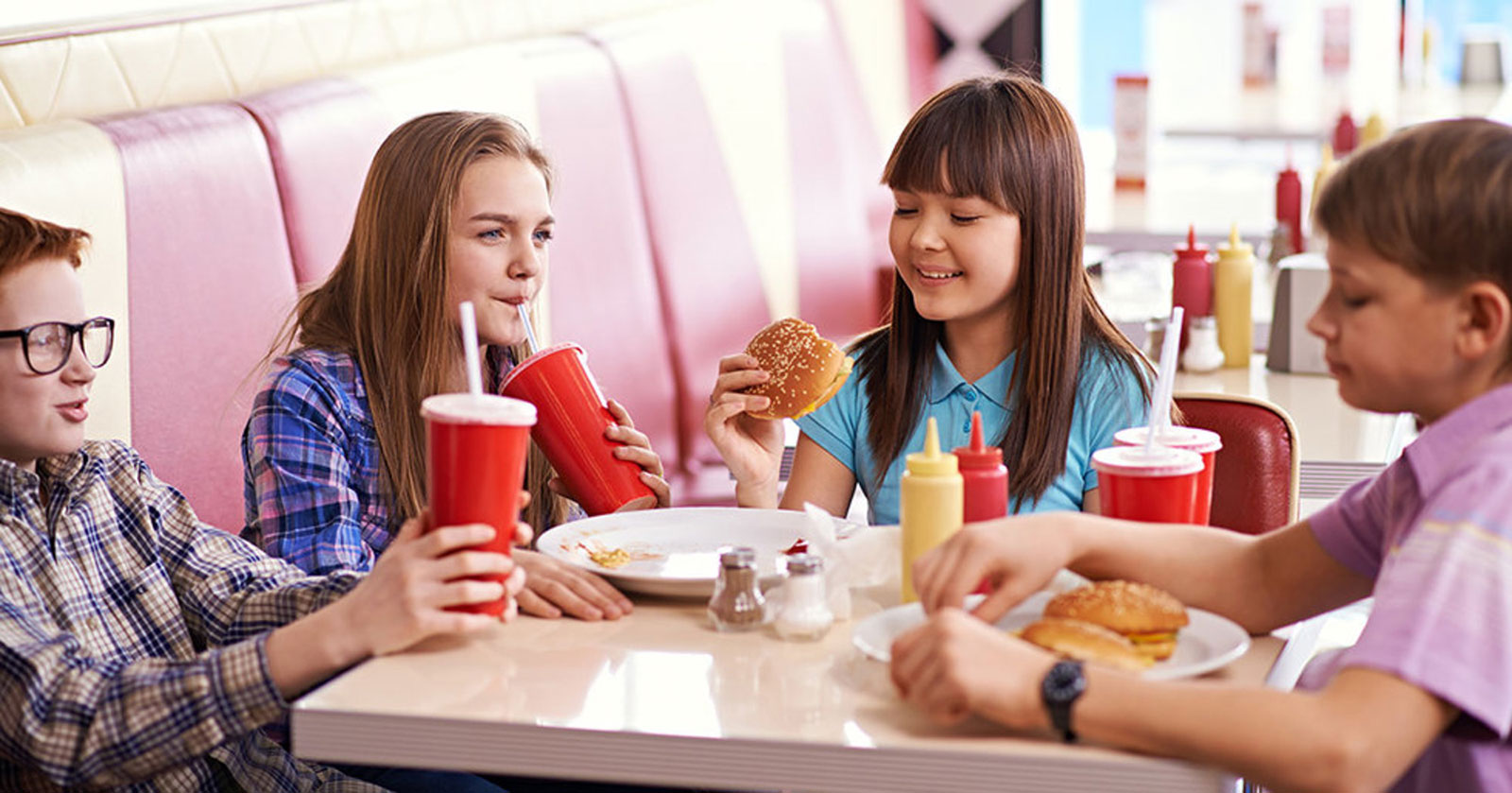 Teenagers Eating At Fast Food restaurant