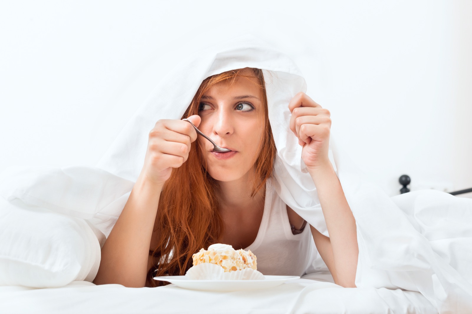 Are You Emotionally Prepared to Make Some Impossible Food Choices? Woman Having Sweet Cake At Bed