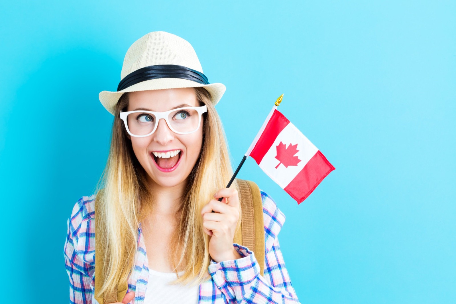 🗺️ Can You Pass This “Jeopardy!” Trivia Quiz About World Geography? Woman Holding Canada Flag