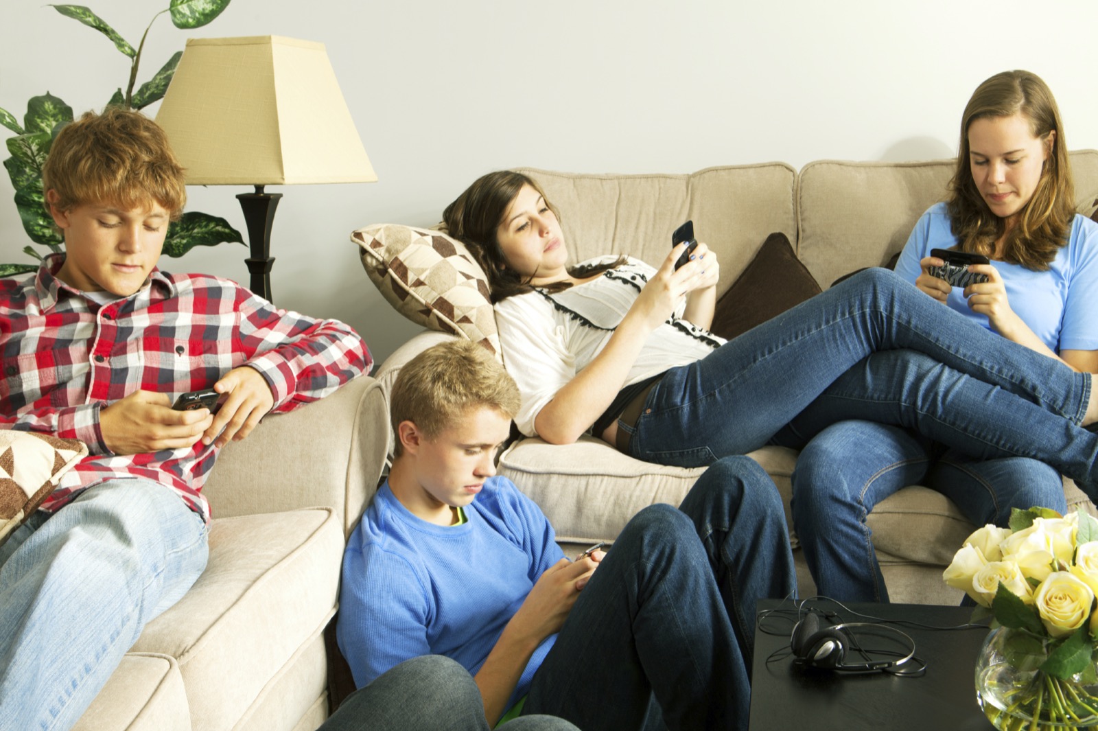 Am I Addicted To My Phone? Quiz Teenagers Texting On Mobile Phones In A Home Setting