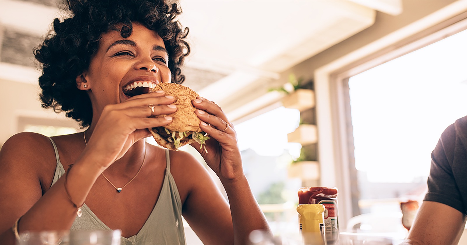 Build Burger & I'll Reveal Condiment That Is You Quiz Woman Enjoying Eating Burger At Restaurant