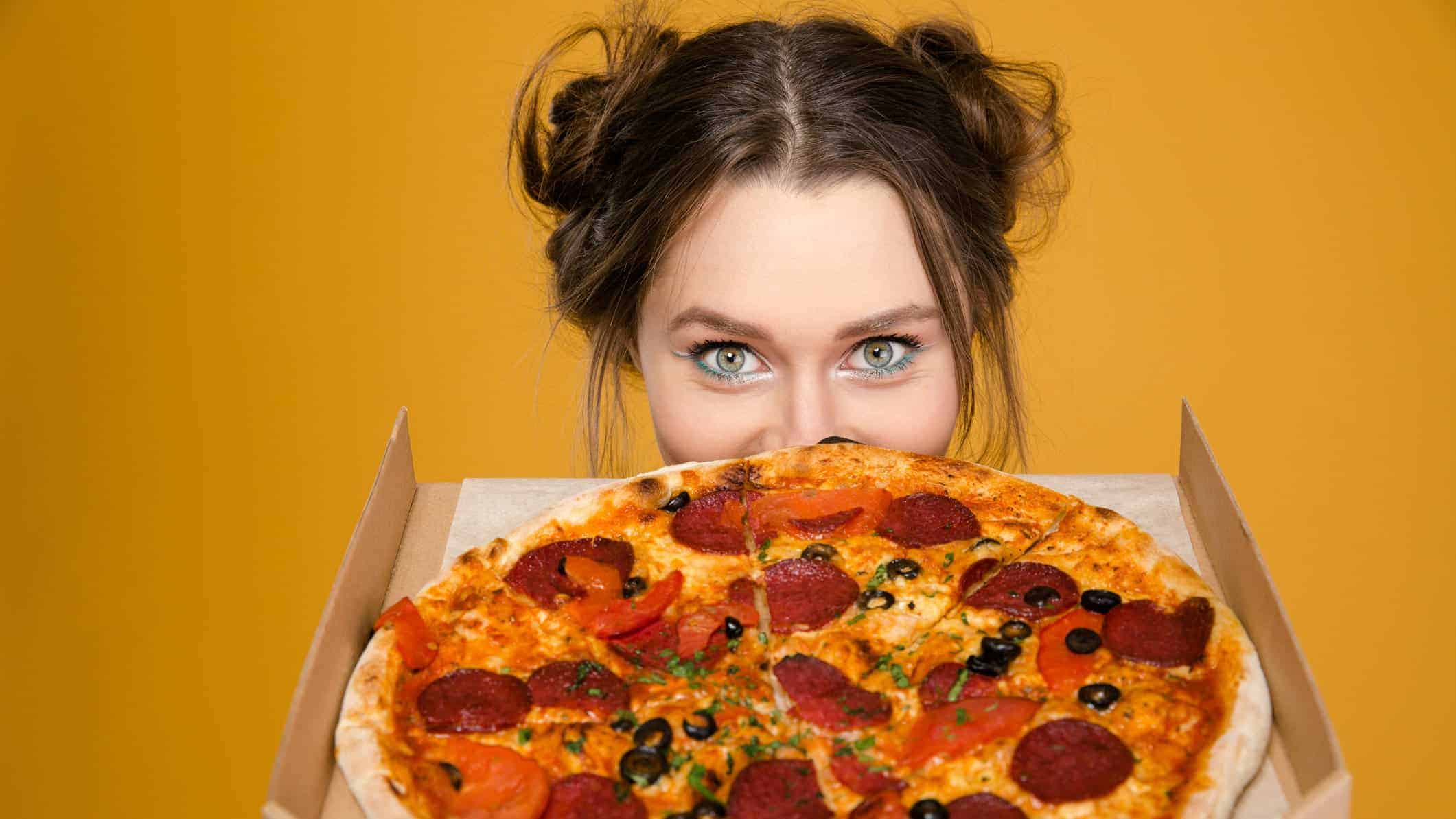 Sorry, But You’re a Picky Eater If You’ve Eaten 17/22 of These Foods Woman Eating Pizza