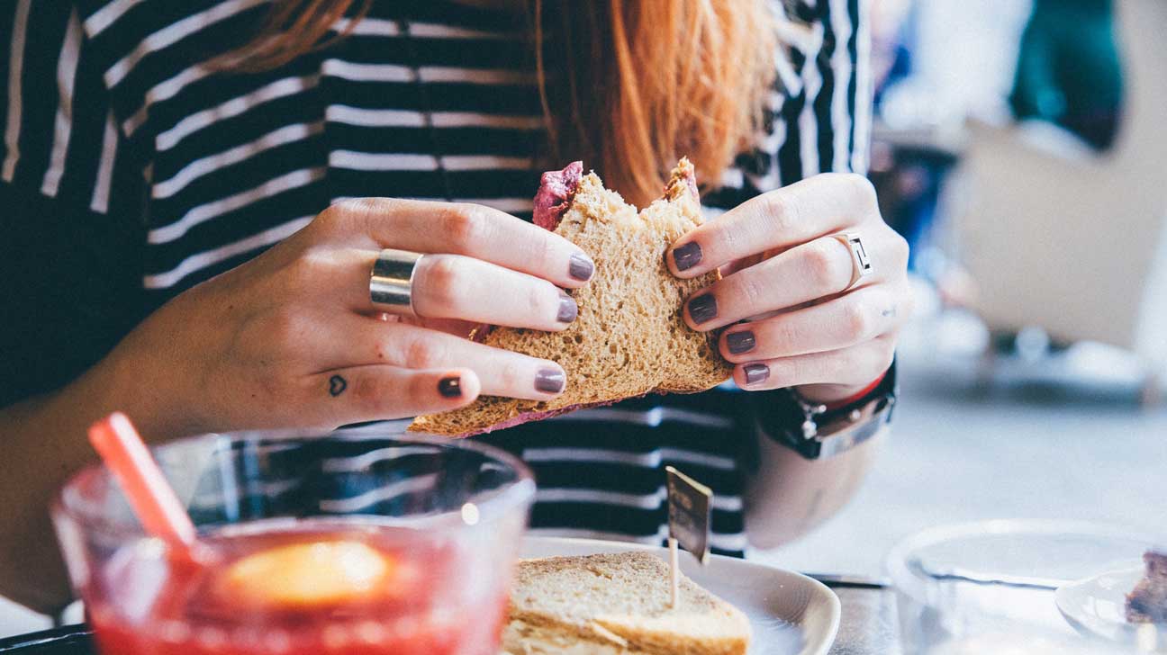 Breakfast Foods Season Quiz Woman Eating Holding Sandwich