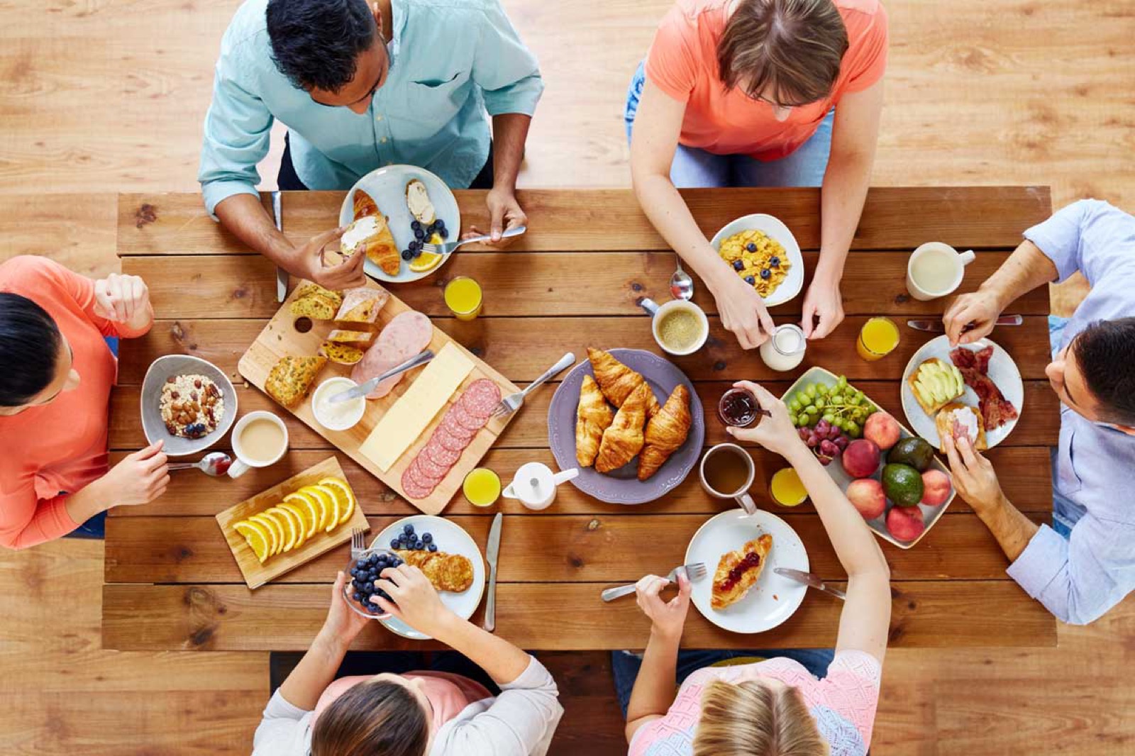 Group Of People Having Breakfast At Table