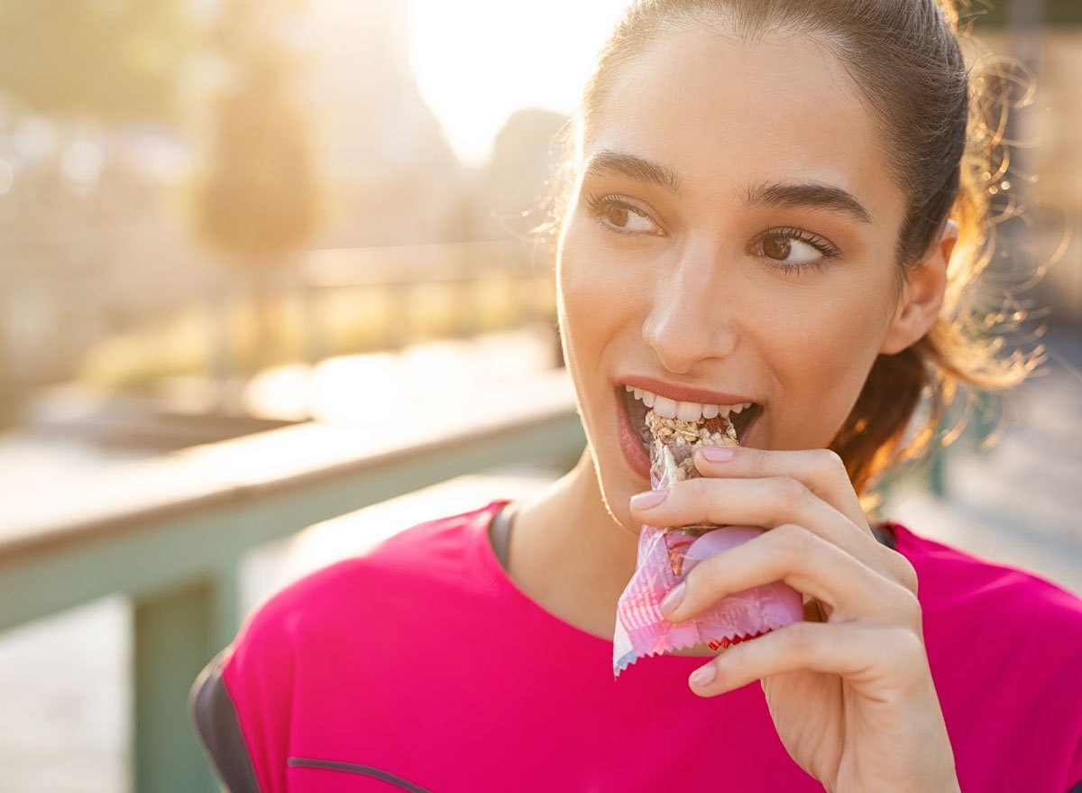 Can We Guess the Generation You’re from Based on How You Define These Words? Woman Eating Protein Bar Snack