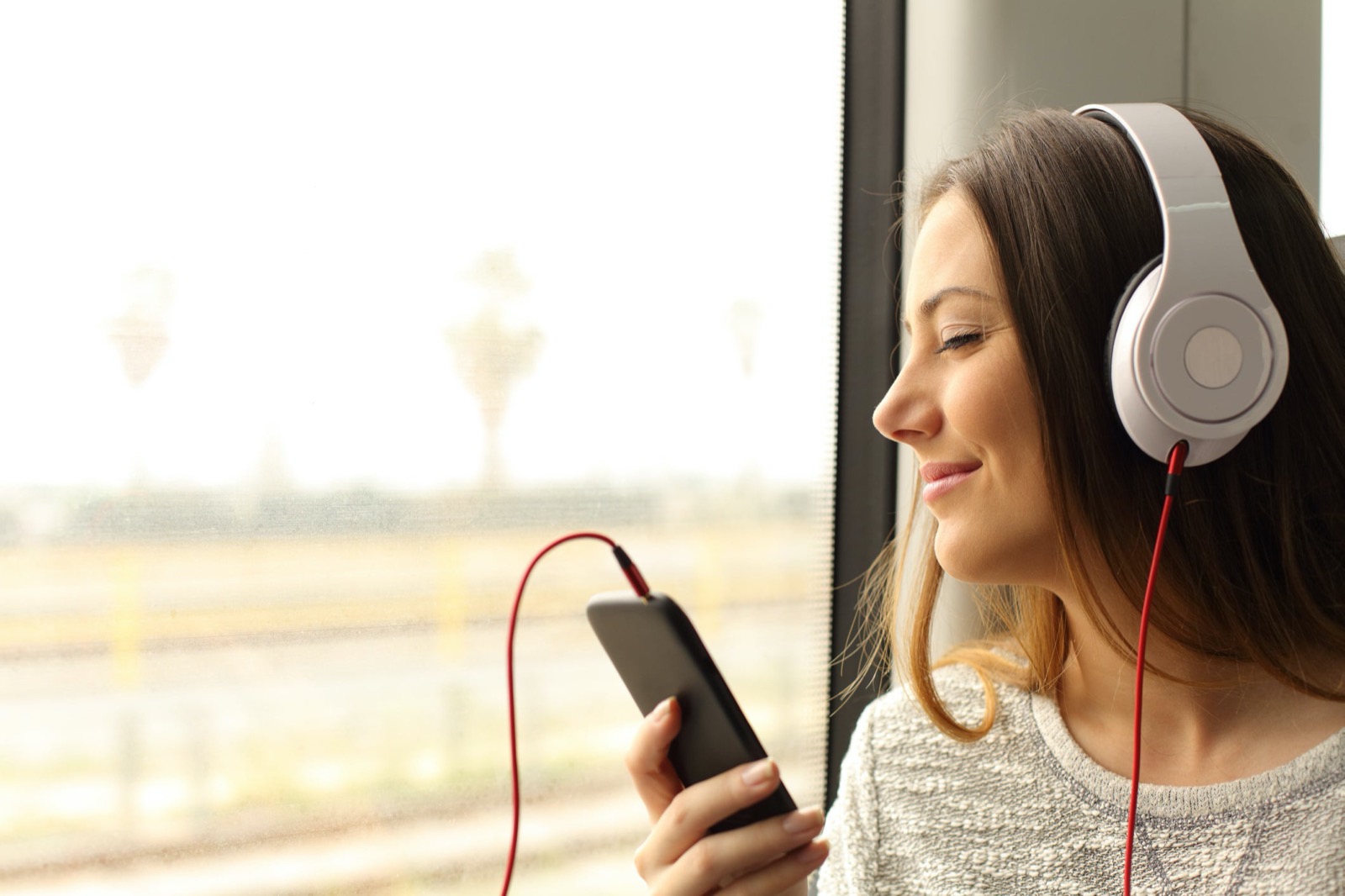 Young Woman Listening To Music With Headphones