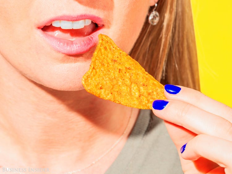 Eat Food for Each Letter & We'll Reveal Your Mental Age Quiz Woman Eating Doritos