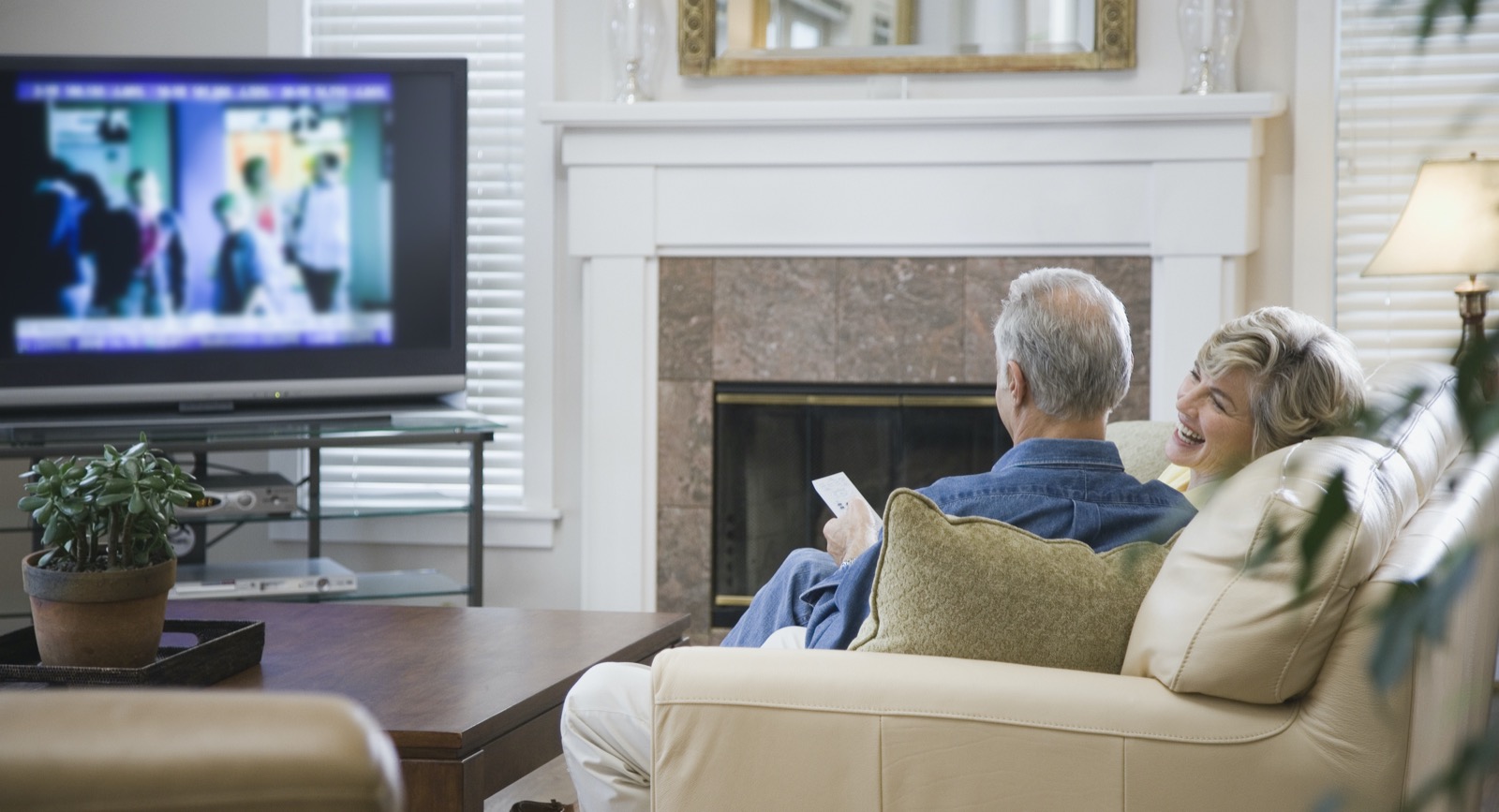 Senior Couple Watching Tv In Living Room