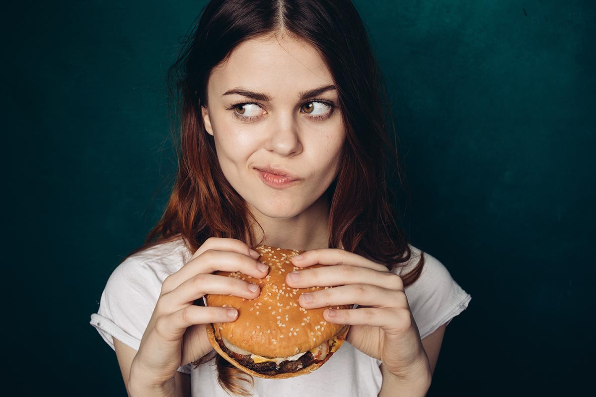 Could You Go on a Vegan, Vegetarian or Pescatarian Diet? Quiz Woman Eating Burger