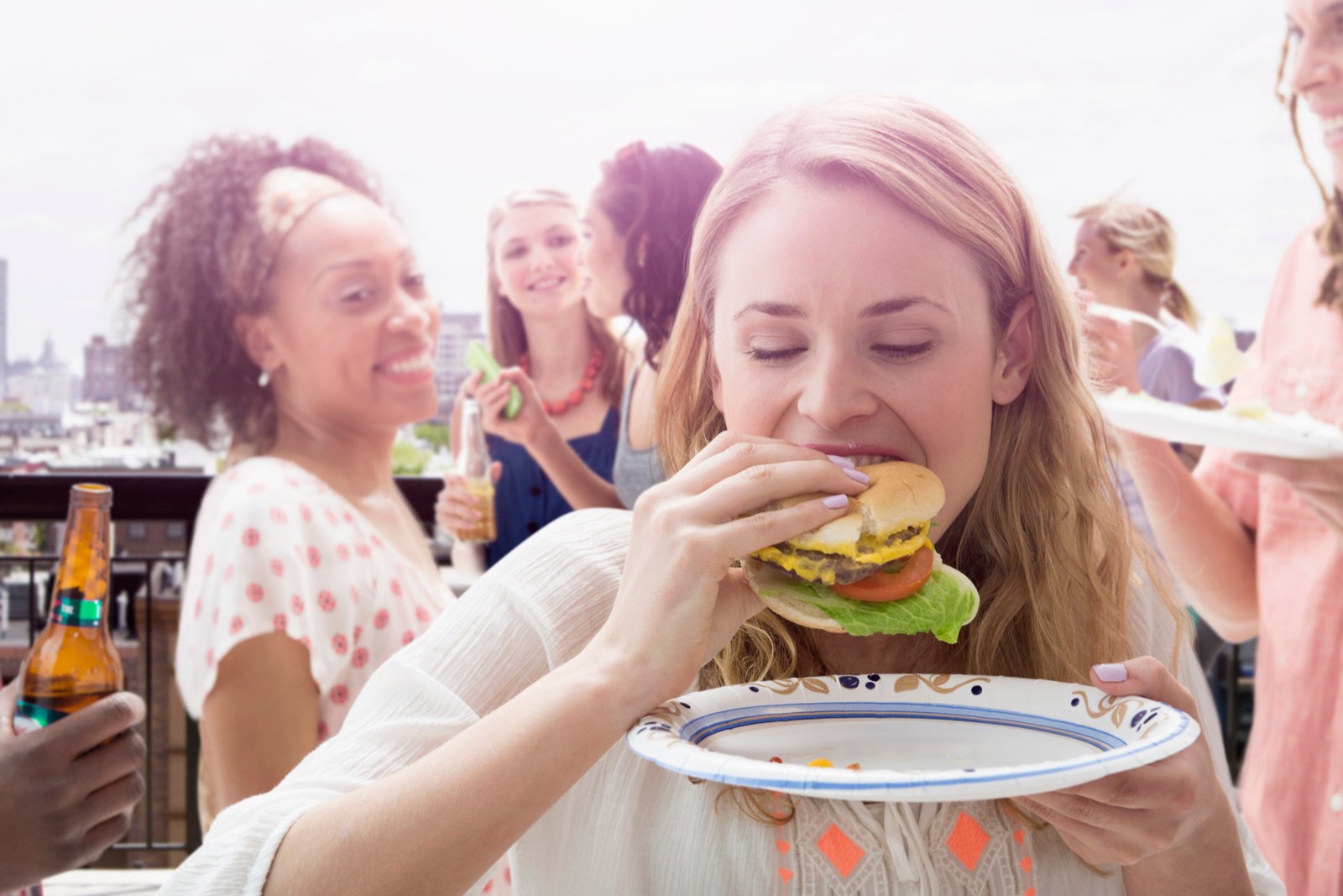 Choose Between These Foods and We’ll Tell You If You Eat Like an Old or Young Person Woman Eating Burger