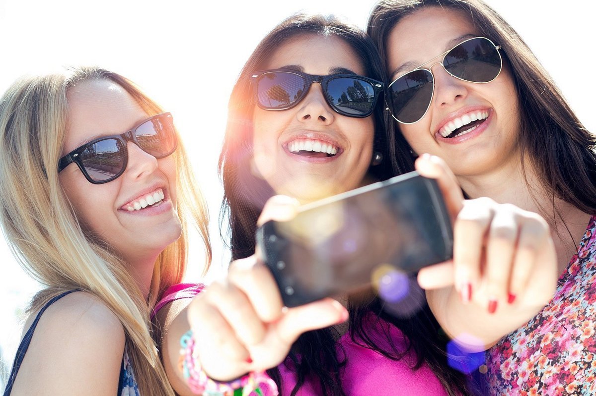 Change Some Things from Your Past and We’ll Reveal How Bright Your Future Is Teenagers using phone selfie