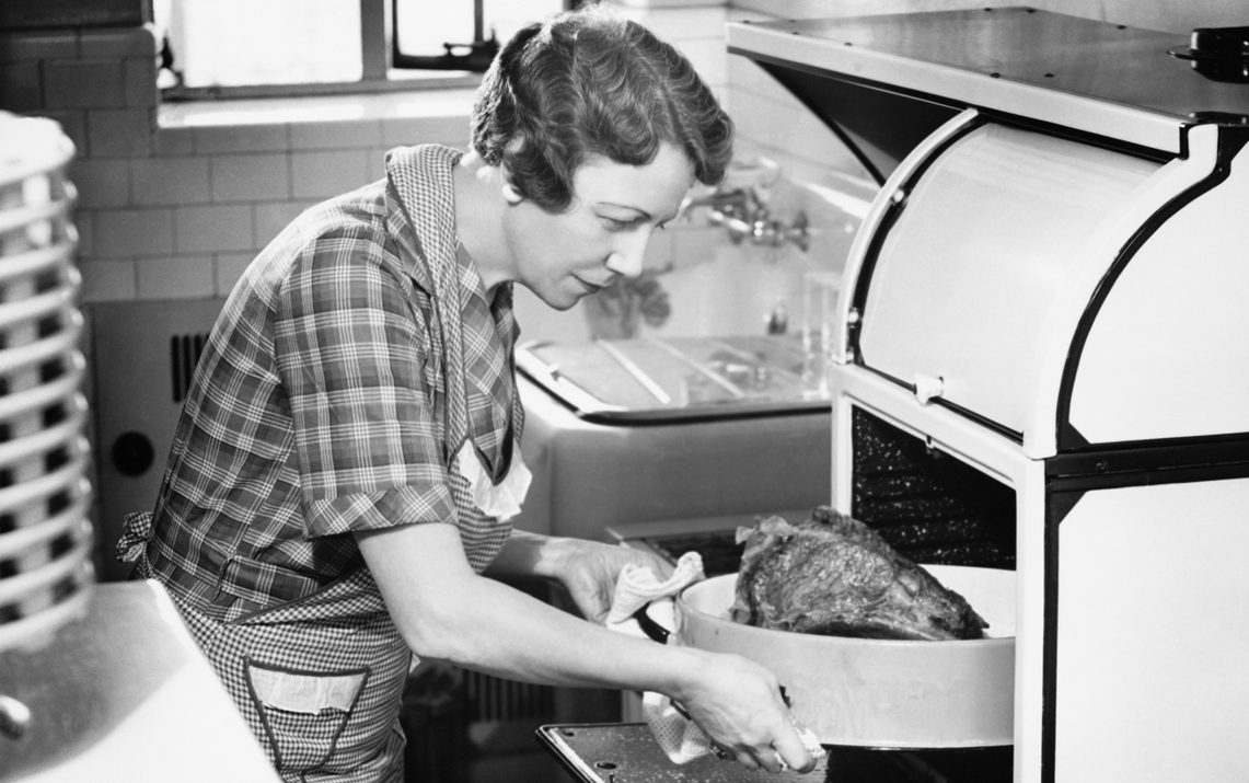 If You Were Born After 1970, There's No Way You're Passing This Food Quiz Housewife removing turkey from oven, (B&W)