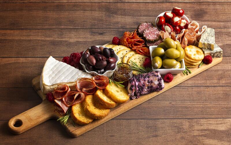 Put Together a 🧀 Charcuterie Board and We’ll Reveal Your Most Desired Comfort Food savoury-charcuterie-board-covered-meats-olives-peppers-berries-cheese-207167728