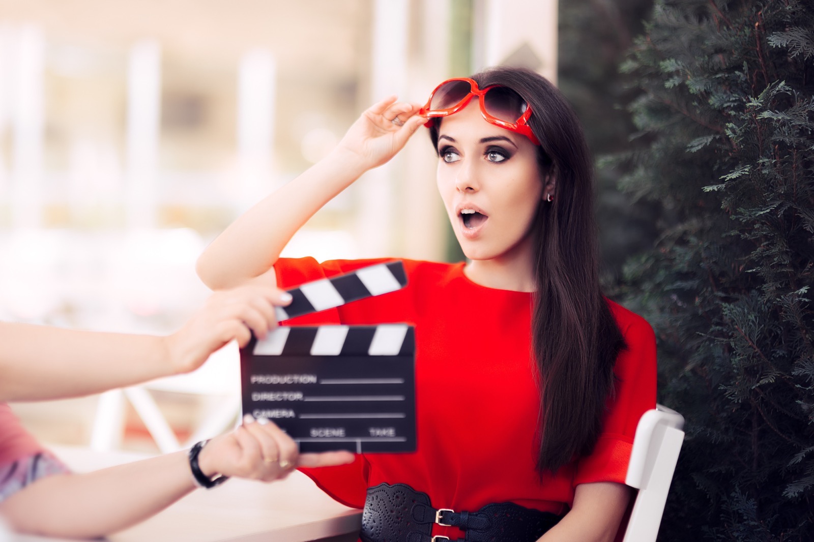 Fun Words Surprised Actress with Oversized Sunglasses Shooting Movie Scene