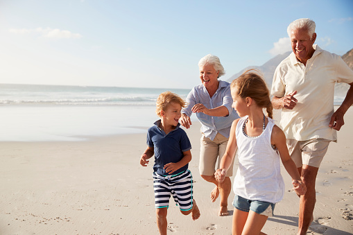 👵 Are You an Awesome Grandparent? 👴 Grandparents Running Along Beach With Grandchildren On Summer Vacation