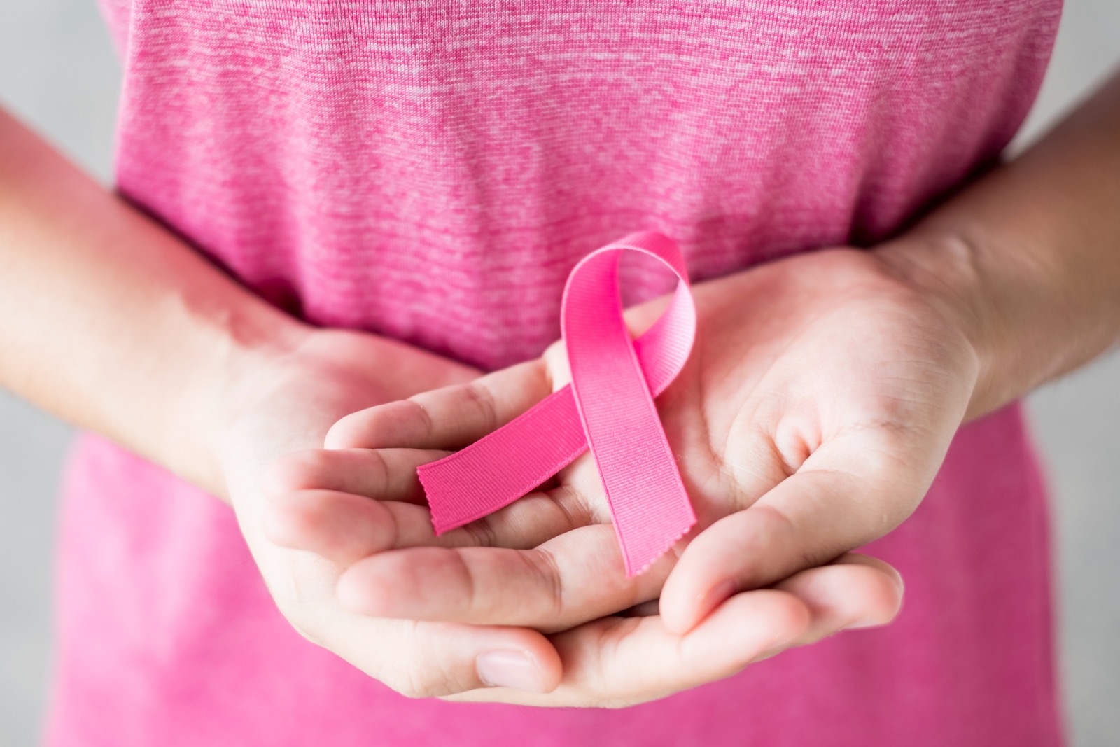 What's Pink? General Knowledge Quiz Breast Cancer Awareness month, Woman in pink T- shirt with hand holding Pink Ribbon for supporting people living and illness. Healthcare, International Women day and World cancer day concept