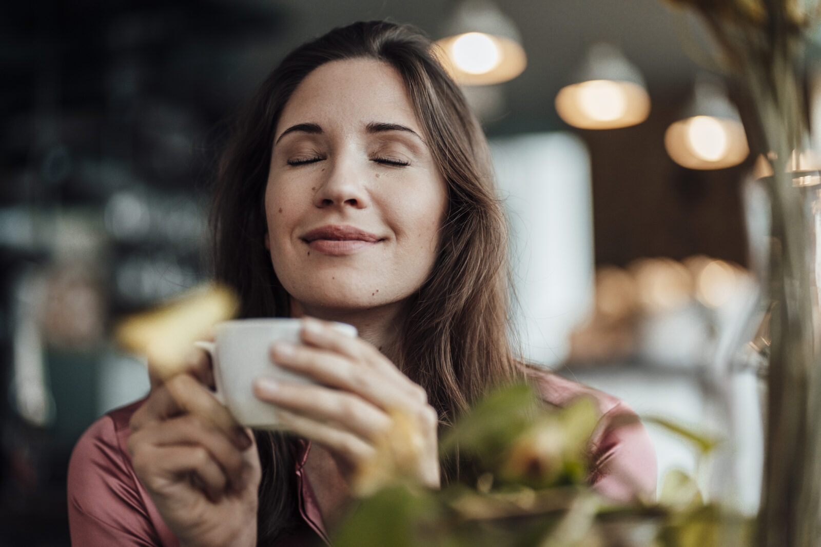 Tea Quiz Smiling businesswoman smelling coffee in cafe