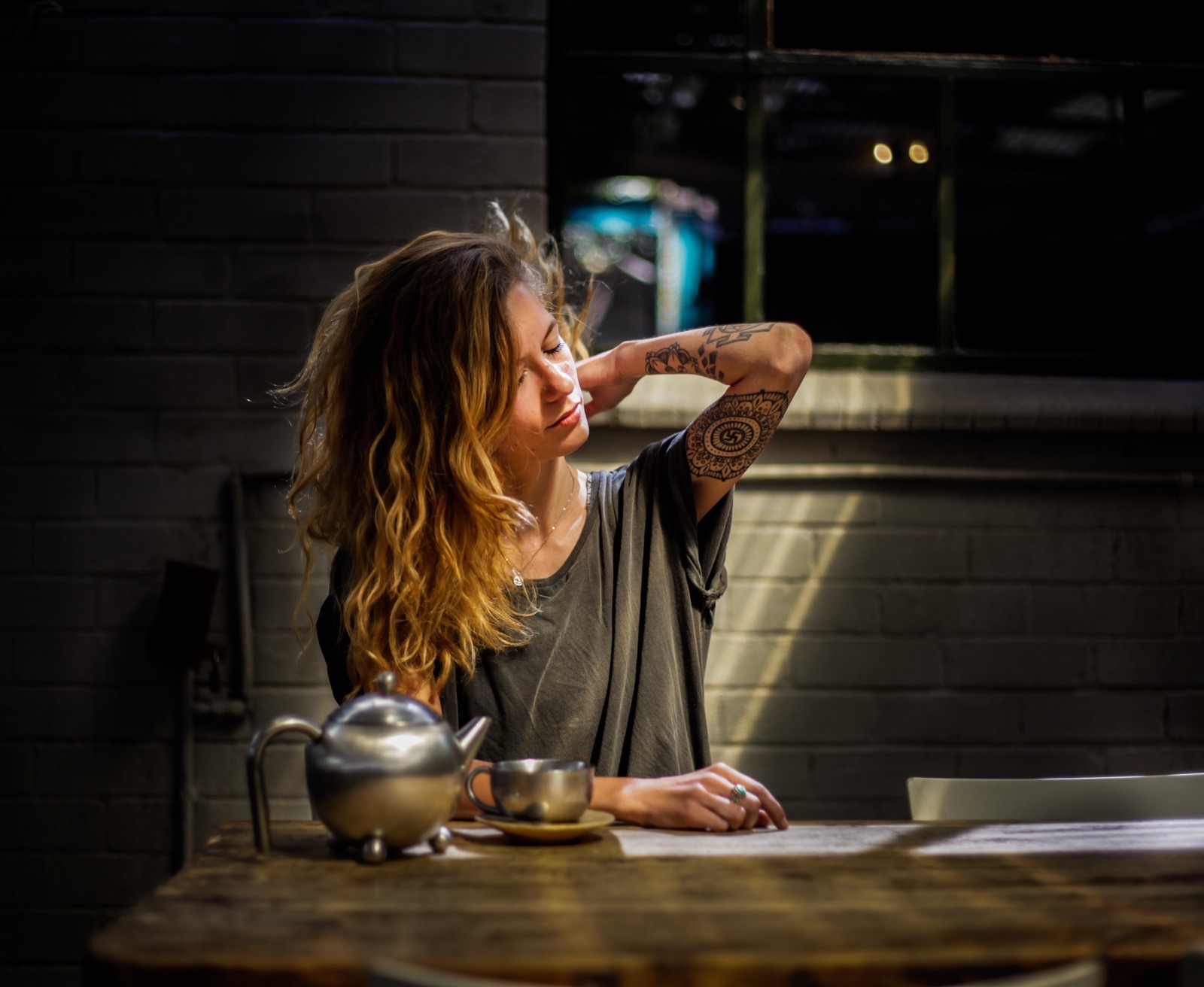 Tea Quiz Tattooed woman drinking tea at night