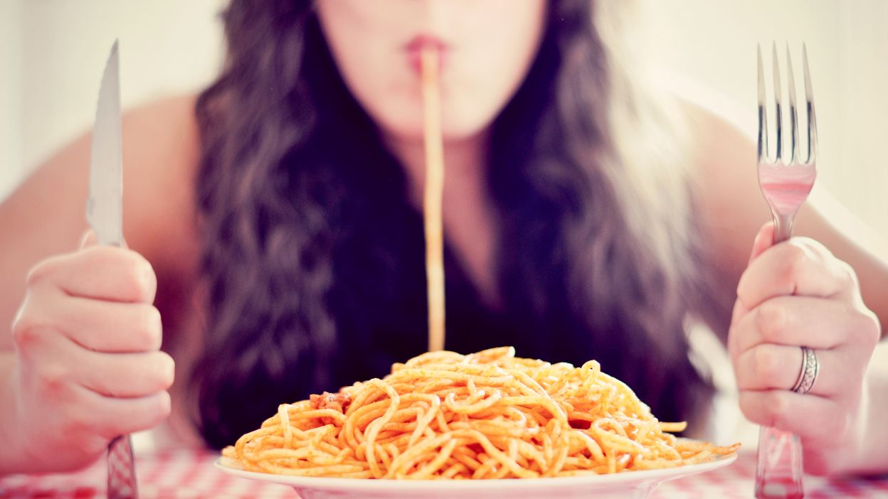 Woman eating spaghetti pasta