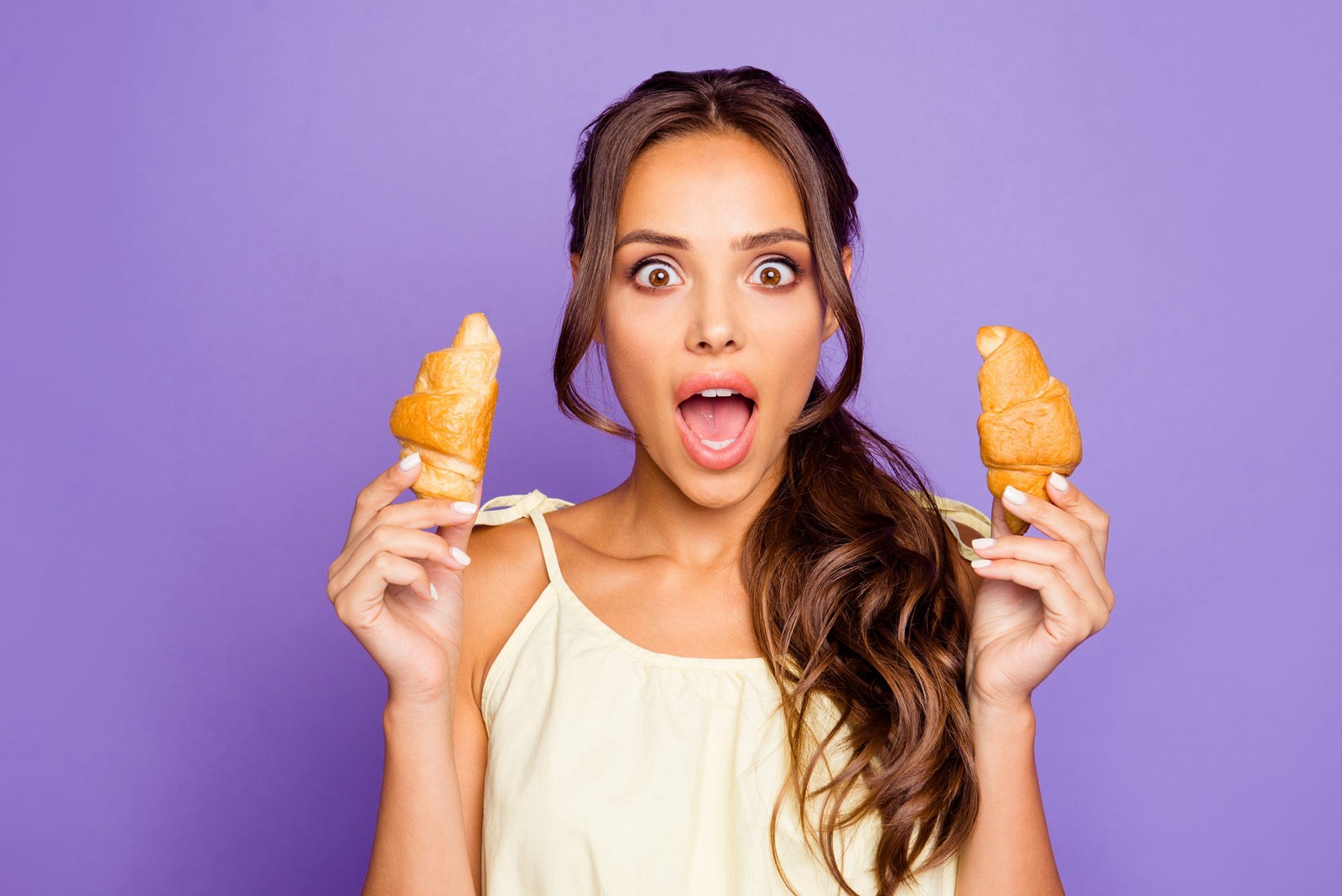 Woman eating croissant