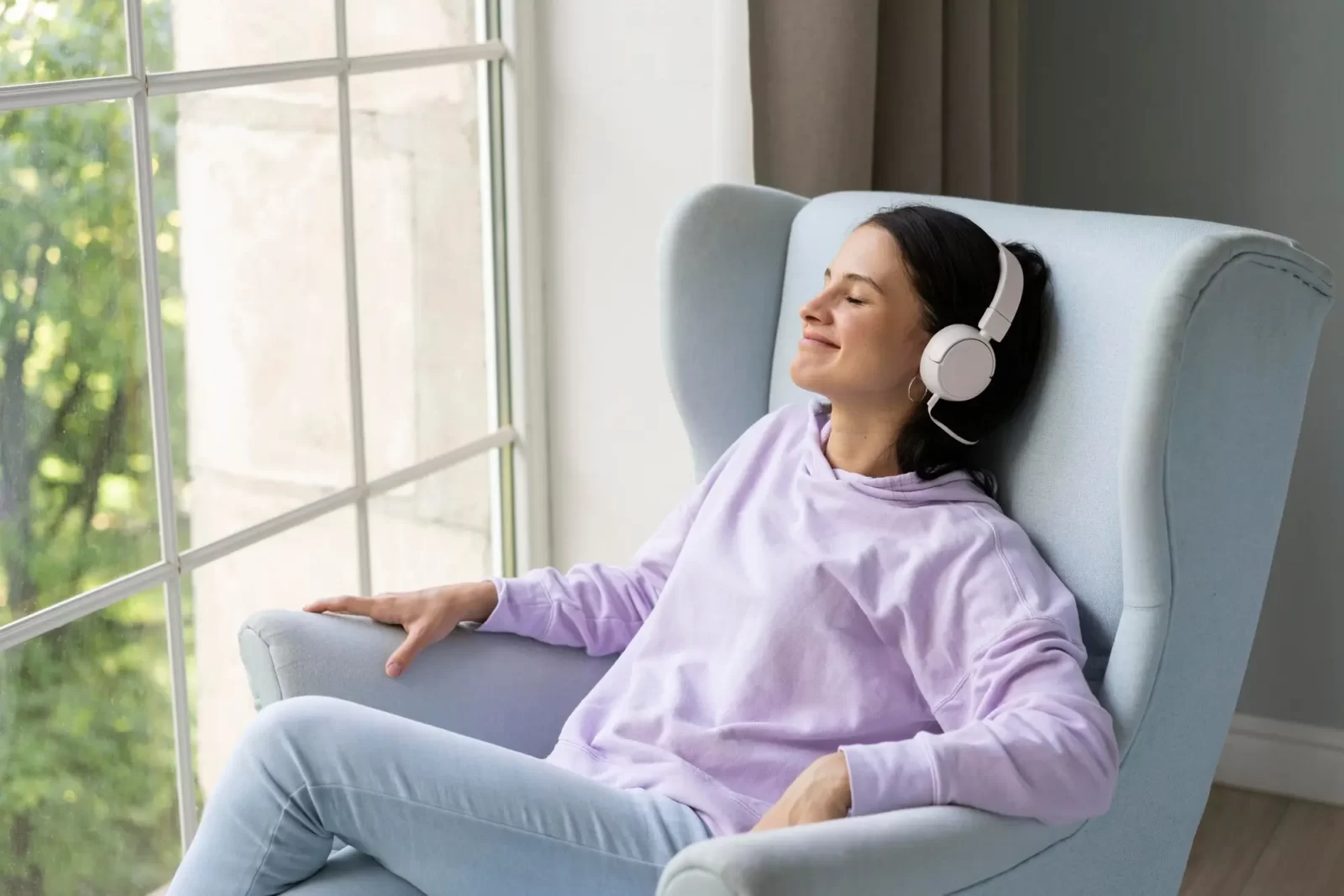 Woman relaxing listening to music at home