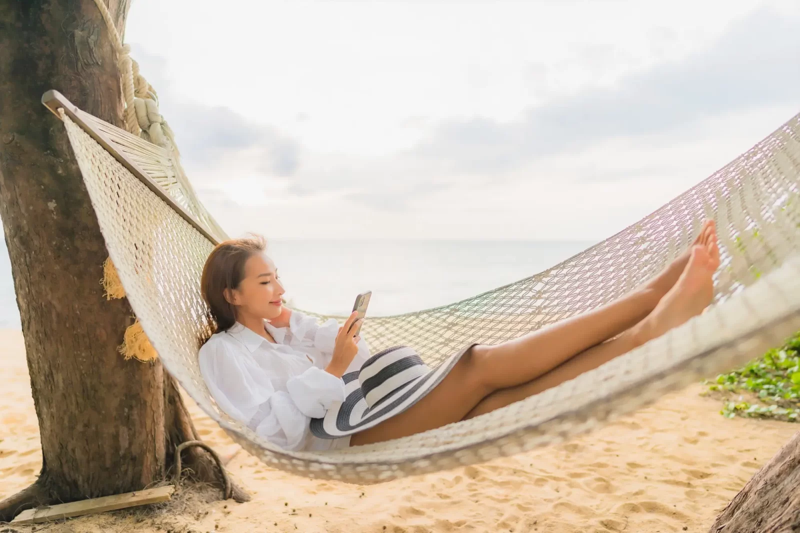 What Type Of Dolphin Are You? Quiz Woman relaxing on hammock around beach in vacation weekend